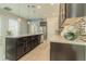 Open-concept kitchen with dark wood cabinetry, stainless steel appliances, and an eat-in island for casual dining at 8268 Bellow St, Orlando, FL 32827