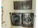 Laundry room features modern washer and dryer with dark cabinets providing ample storage space at 8268 Bellow St, Orlando, FL 32827