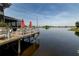 Waterfront patio with orange umbrellas and tables offers beautiful scenery and relaxing outdoor dining by the water at 8268 Bellow St, Orlando, FL 32827