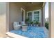 Covered patio featuring wicker furniture, decorative blue rug, and potted plants at 8268 Bellow St, Orlando, FL 32827