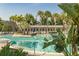 Community pool surrounded by palm trees and lounge chairs offering a relaxing vacation experience at 8268 Bellow St, Orlando, FL 32827