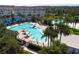 Aerial view of community pool area with cabanas, multiple pools and tropical landscaping at 8268 Bellow St, Orlando, FL 32827