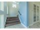 Staircase with wood stairs, tile flooring, and crisp blue wall at 8268 Bellow St, Orlando, FL 32827