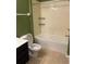 Bathroom featuring a shower-tub combo, a black vanity, and tan tile flooring at 8775 Sartori St # 307, Orlando, FL 32829
