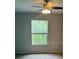 Bedroom featuring a ceiling fan and a window bringing in natural light at 8775 Sartori St # 307, Orlando, FL 32829