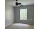 Inviting bedroom with neutral walls, ceiling fan, and a window for natural light at 8775 Sartori St # 307, Orlando, FL 32829