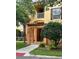 Inviting condo building featuring a charming entrance, balcony, and beautiful landscaping at 8775 Sartori St # 307, Orlando, FL 32829