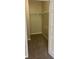 Empty walk-in closet with a hanging bar and shelving for organization and storage at 8775 Sartori St # 307, Orlando, FL 32829