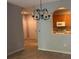 Open-concept dining area with chandelier and archway to the kitchen at 8775 Sartori St # 307, Orlando, FL 32829
