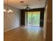 Spacious living room with tile floors, ceiling fan and large sliding glass door to screened lanai at 8775 Sartori St # 307, Orlando, FL 32829