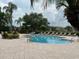 An inviting community pool is surrounded by ample lounge chairs and mature landscaping at 8775 Sartori St # 307, Orlando, FL 32829