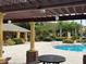 Community pool with patio furniture and landscaping creates a relaxing outdoor space at 8775 Sartori St # 307, Orlando, FL 32829