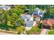 Overhead view of a home with a grey roof and a well manicured, green lawn, surrounded by mature trees at 879 Matt Ln, Port Orange, FL 32127