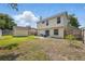 Spacious backyard with patio seating, storage shed, and lush green grass at 879 Matt Ln, Port Orange, FL 32127