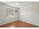 Cozy bedroom with a window providing natural light and wood flooring at 879 Matt Ln, Port Orange, FL 32127