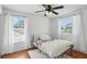 Light and airy bedroom featuring a ceiling fan and two windows for plenty of natural light at 879 Matt Ln, Port Orange, FL 32127