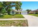 Charming two-story home with a well-maintained lawn and a large tree providing shade at 879 Matt Ln, Port Orange, FL 32127
