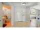 Inviting foyer with tiled flooring leading to the bathroom, entry door, and main living spaces at 879 Matt Ln, Port Orange, FL 32127