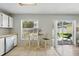 Bright breakfast nook with tile flooring and sliding glass doors to the backyard at 879 Matt Ln, Port Orange, FL 32127