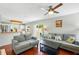 Open-concept living room adjacent to the kitchen and with sliding glass doors to the backyard at 879 Matt Ln, Port Orange, FL 32127