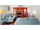 Cozy living room with brick fireplace, ceiling fan, and bright red accent wall at 879 Matt Ln, Port Orange, FL 32127