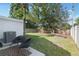 Serene backyard with lush green grass, a patio area, and comfortable seating at 9987 Triple Crown Cir, Orlando, FL 32825