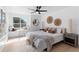 Bright bedroom features a cozy window seat, stylish decor, and a ceiling fan at 9987 Triple Crown Cir, Orlando, FL 32825