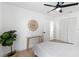 Spacious bedroom with a stylish table and a large plant at 9987 Triple Crown Cir, Orlando, FL 32825