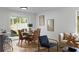 Cozy dining area with wicker chairs, large window, and access to the backyard, perfect for entertaining at 9987 Triple Crown Cir, Orlando, FL 32825