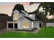 Charming two-story home featuring a modern black-and-white color scheme, well-manicured lawn, and a two-car garage at 9987 Triple Crown Cir, Orlando, FL 32825