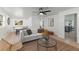 Well-lit living room boasts a comfortable sofa, stylish decor, and a ping pong table for entertainment at 9987 Triple Crown Cir, Orlando, FL 32825