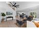Open concept living room with high ceilings, modern decor, and a seamless flow to the kitchen and dining area at 9987 Triple Crown Cir, Orlando, FL 32825