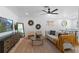 Bright living room features a modern sofa, stylish decor, and a ceiling fan for added comfort at 9987 Triple Crown Cir, Orlando, FL 32825