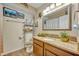 Bathroom featuring wood cabinets, granite countertops, and decorative aquatic themed decor at 3715 S Lake Orlando Pkwy # 11, Orlando, FL 32808