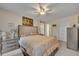 Bedroom featuring neutral decor, a ceiling fan, and an ensuite bathroom at 3715 S Lake Orlando Pkwy # 11, Orlando, FL 32808