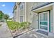 Charming home exterior with lush landscaping and a cozy entryway featuring a glass storm door at 3715 S Lake Orlando Pkwy # 11, Orlando, FL 32808