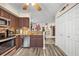 Kitchen with stainless steel dishwasher, wood cabinets, and view into the adjacent room at 3715 S Lake Orlando Pkwy # 11, Orlando, FL 32808