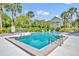 Community swimming pool surrounded by palm trees and a building at 3715 S Lake Orlando Pkwy # 11, Orlando, FL 32808