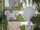 An aerial view of a neighborhood with houses, a cul-de-sac, and solar panels on the rooftops at 1012 Marisol Ct, Orlando, FL 32828