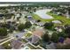 Neighborhood aerial view showcasing houses, solar panels, a community lake, and green spaces at 1012 Marisol Ct, Orlando, FL 32828