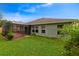 Lush backyard with a screened patio and mature landscaping at 1012 Marisol Ct, Orlando, FL 32828
