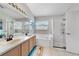 Bright bathroom features double sinks, bathtub, and a separate glass-door shower at 1012 Marisol Ct, Orlando, FL 32828