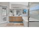 Bright bathroom featuring double vanity, tub, and shower with glass door, bright and airy space at 1012 Marisol Ct, Orlando, FL 32828