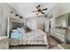 Serene bedroom featuring a queen-sized bed and a ceiling fan at 1012 Marisol Ct, Orlando, FL 32828