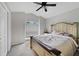 Cozy bedroom with a decorative bed, large window, and ceiling fan at 1012 Marisol Ct, Orlando, FL 32828