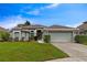 Charming single-story home featuring a well-manicured lawn and attached two-car garage at 1012 Marisol Ct, Orlando, FL 32828