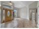 Inviting foyer featuring a decorative wood door, tile flooring, and ample natural light at 1012 Marisol Ct, Orlando, FL 32828