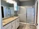 Bathroom featuring double vanity, granite countertops, and tiled shower with glass door at 10126 Beach Port Dr, Winter Garden, FL 34787