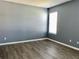 Light and airy bedroom with laminate flooring, a large window, and neutral paint at 10126 Beach Port Dr, Winter Garden, FL 34787