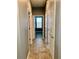 Hallway with tiled flooring leads to bedrooms and bathrooms at 10126 Beach Port Dr, Winter Garden, FL 34787
